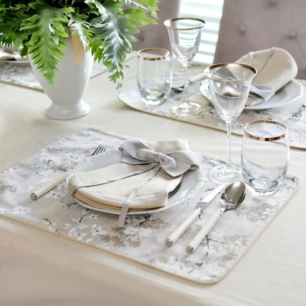 Double-sided cotton placemat set with gray twig embroidery and beige reverse styled side view.