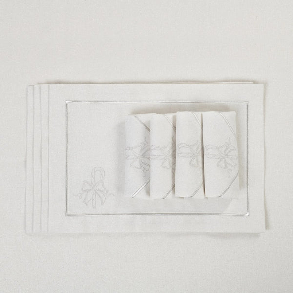 Candy Cane embroidered napkins folded on matching tablecloth.
