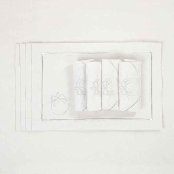 Luxury silver Christmas bauble embroidered napkins by Roseberry Home folded on matching tablecloth.