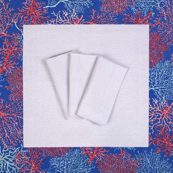 Amiramour Griggio Linen Napkins by Roseberry Home presented on seaweed motif tablecloth