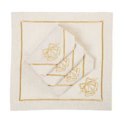 Folded light beige napkin with embroidered Christmas bell design on white background.