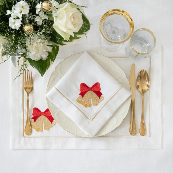 Roseberry Home Jingle Bells napkins with elegant Christmas bell motif folded on plate.