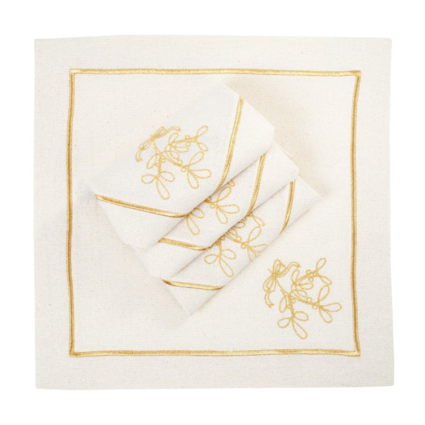 Folded light beige napkins with gold embroidered mistletoe motif on white background.