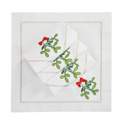Napkin with delicate mistletoe embroidery on Italian cotton folded on white background.