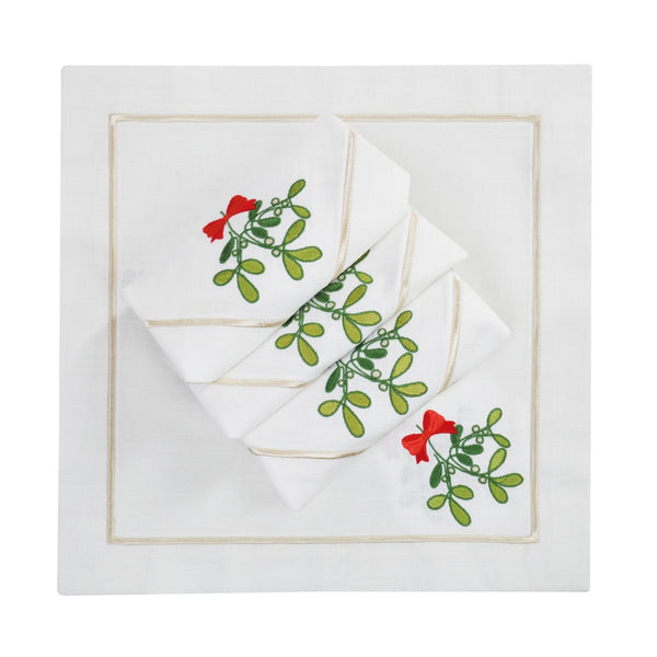 Napkin with delicate mistletoe embroidery on Italian cotton folded on white background.