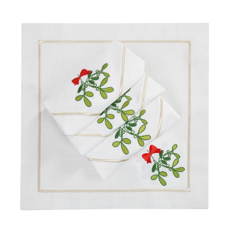Napkin with delicate mistletoe embroidery on Italian cotton folded on white background.