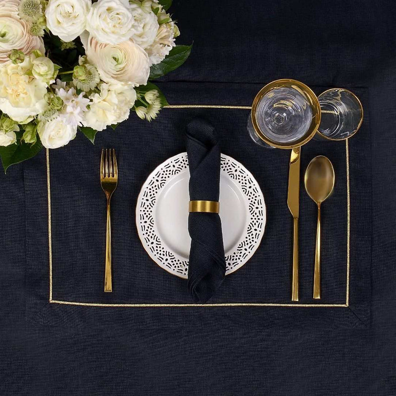 Black linen napkin by Roseberry Home styled with gold napkin ring, sold at Amiramour.