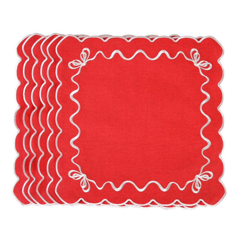 Unwrapped red cotton napkin with white embroidered festive bows in the corners.