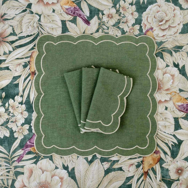 Folded Green Petali napkin with wave-shaped border on tablecloth with flowers, at Amiramour.