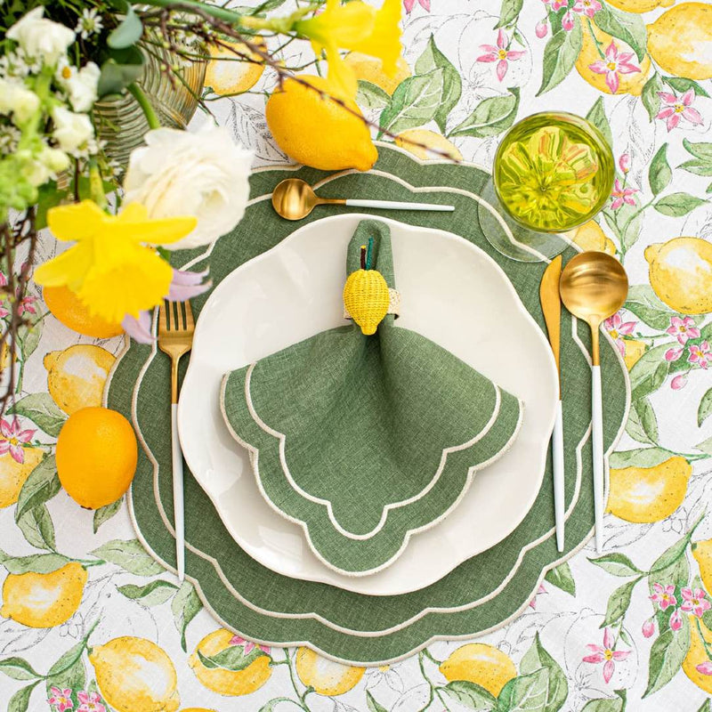 Green Petali napkin with wave-shaped border styled with lemon motif napkin ring.
