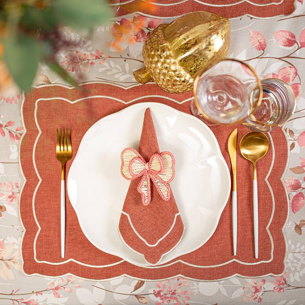 Roseberry Home Rust Onde embroidered napkin gracefully set for a festive luxury dinner.
