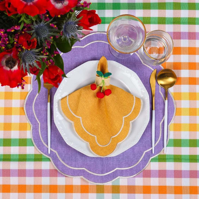 Styled Yellow Petali napkin on purple petali placemat with rattan cherry napkin ring, sold by Amiramour 