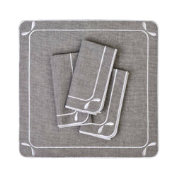 Folded Dragonfly embroidered cotton napkins in grey by Roseberry Home, on white background.
