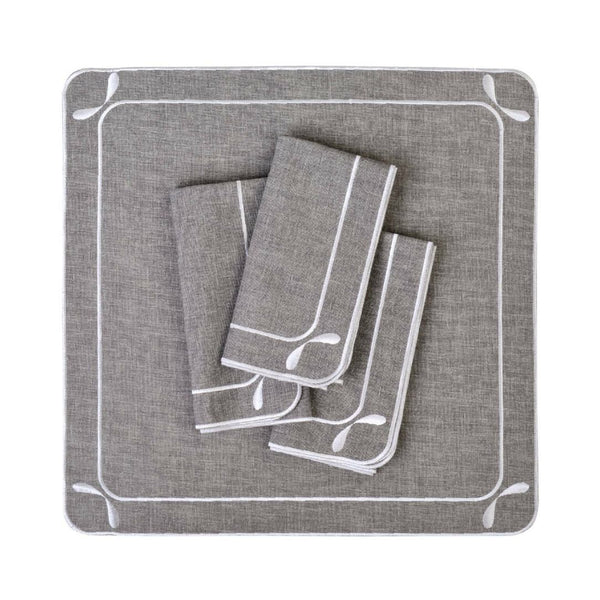 Folded Dragonfly embroidered cotton napkins in grey by Roseberry Home, on white background.
