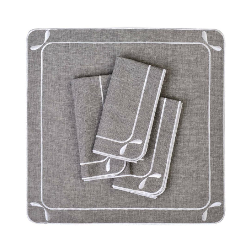 Folded Dragonfly embroidered cotton napkins in grey by Roseberry Home, on white background.