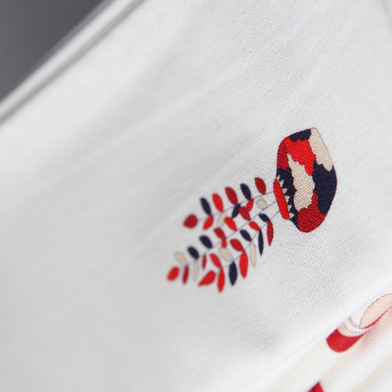 Close-up of red and blue plant print on Baba a la Grenade napkin ,Alto Duo, Amiramour