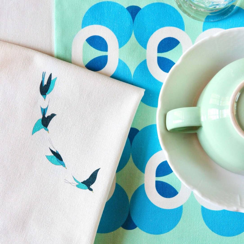 Close-up of green and blue birds print on Baba a la Grenade napkin by Alto Duo, Amiramour