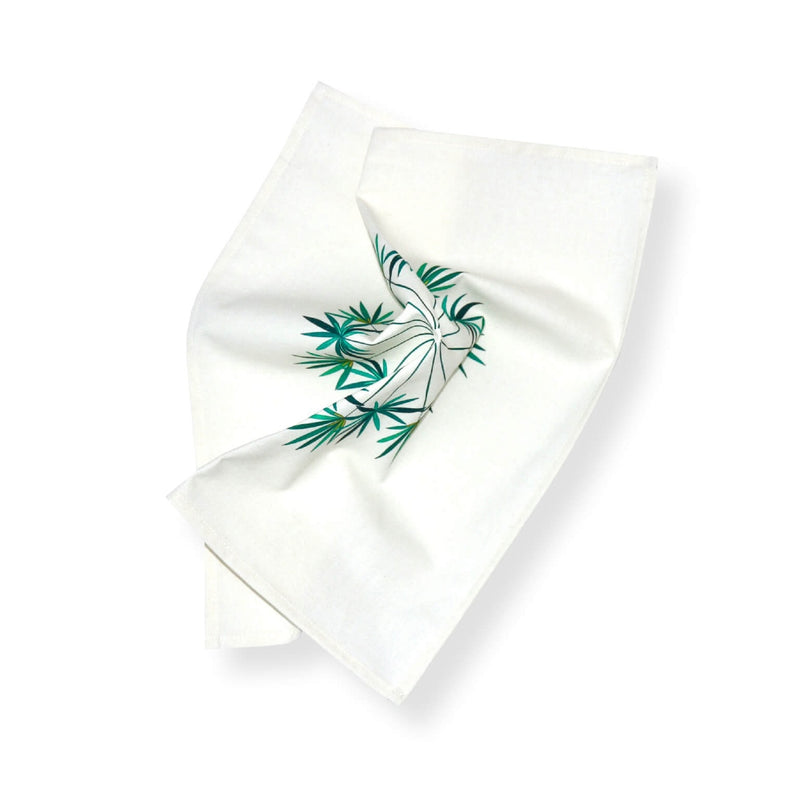 Close-up of green and blue palm tree print on Baba a la Grenade napkin by Alto Duo, Amiramour