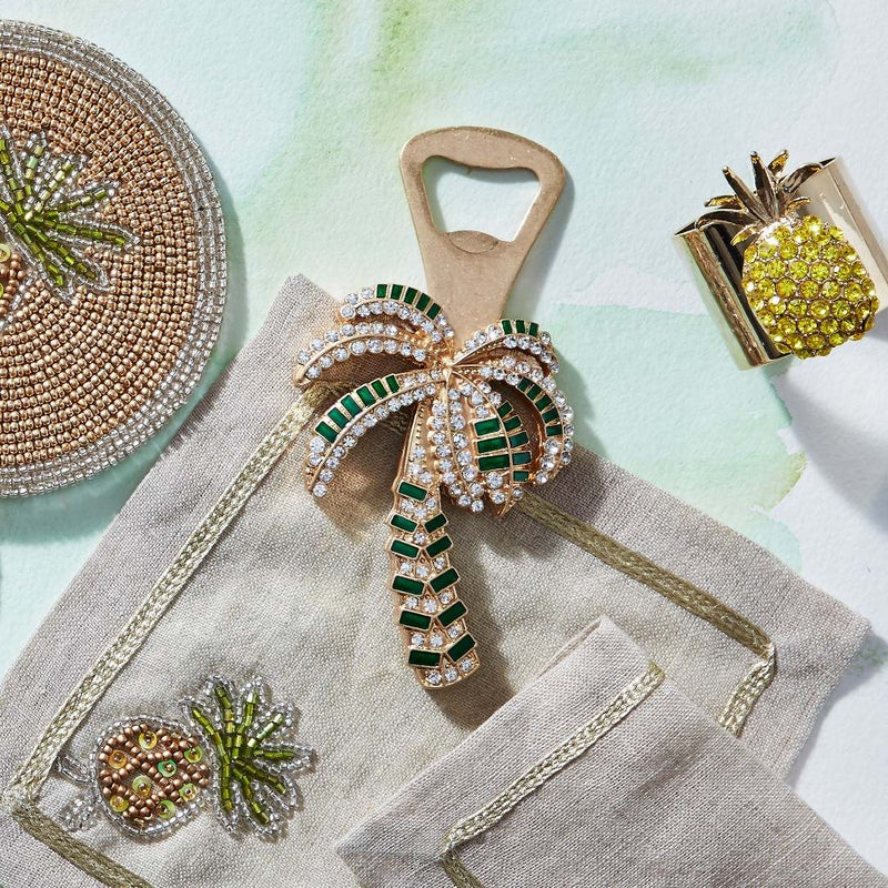 Crystal pineapple napkin ring with gold leaves and yellow base on summer tablescape
