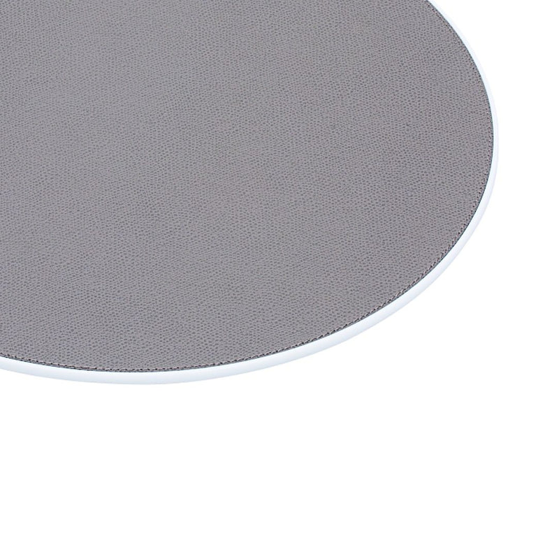 Round Corian placemat with leather insert by Giobagnara in grey, close-up.