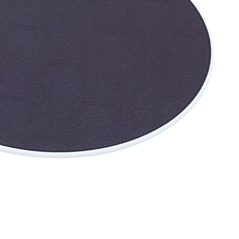 Round Corian placemat with leather insert by Giobagnara in navy, close-up.
