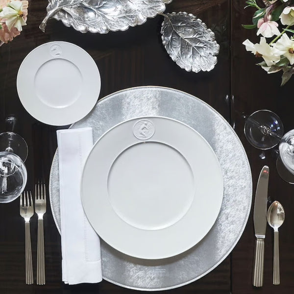 Reversible faux leather placemat in silver and gold on luxury silver tablescape.