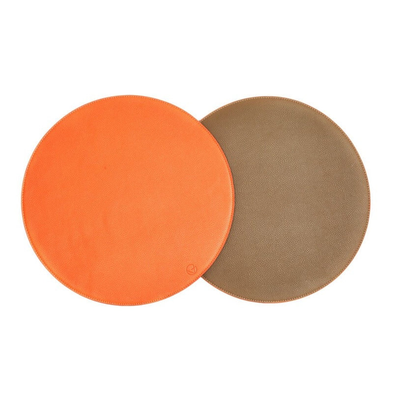 Reversible placemat in taupe and orange faux leather by Von Gern Home.