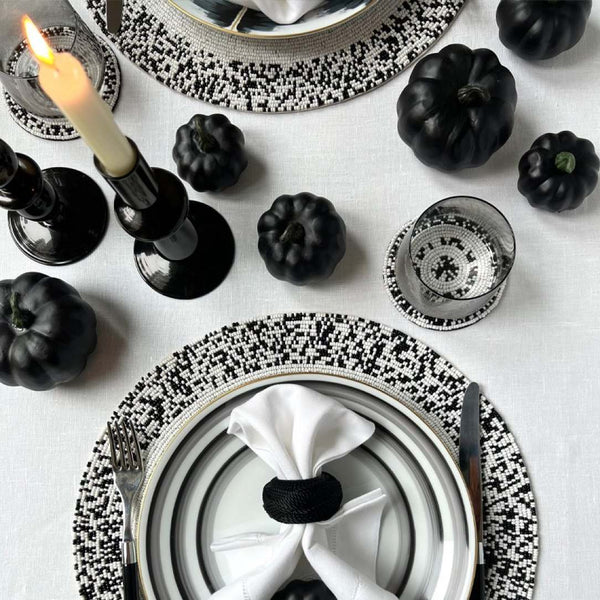 Black and white hand-beaded placemats by Von Gern Home on Halloween tablescape.