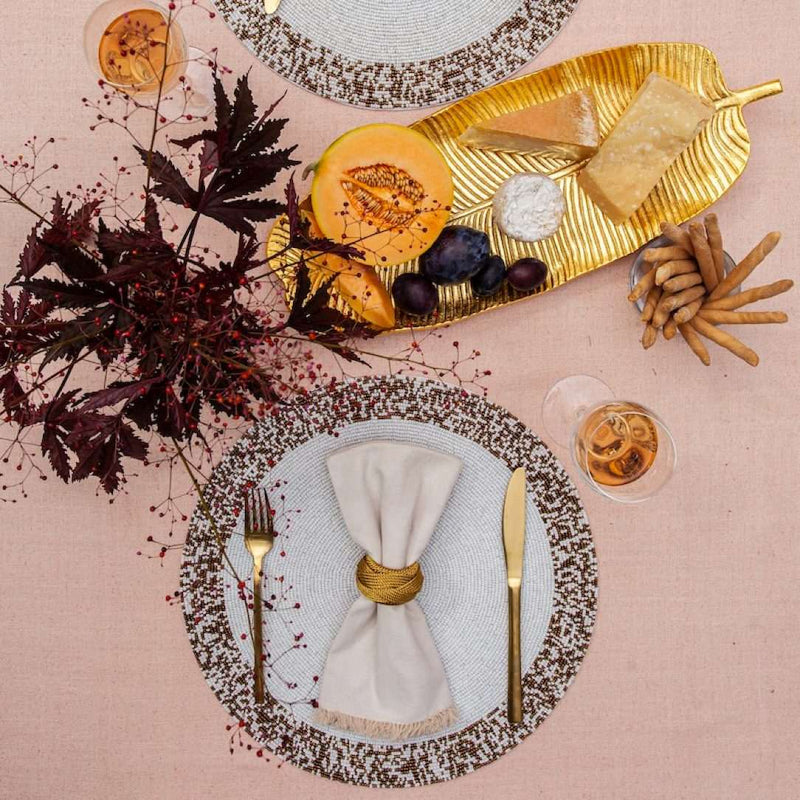 Von Gern Home Splatter placemat in bronze and white beads styled fall table.