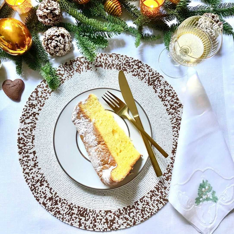 Von Gern Home Splatter placemat in bronze and white beads styled on festive table.