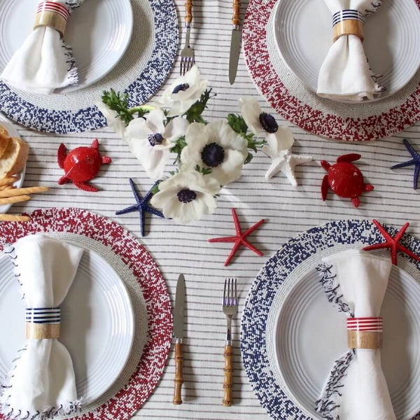 Hand-beaded placemat in navy and white beadson coastal tablescape.