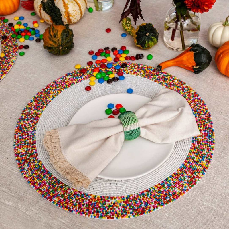 Von Gern Home Sprinkles placemat with colorful bead border on Halloween table.