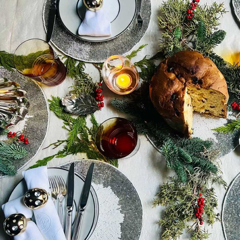 Celebration placemat with silver beaded border and white center on luxury Christmas tablescape.