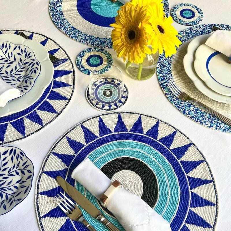 Blue hand-beaded placemat with tribal pattern with matching coasters.