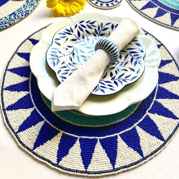 Blue hand-beaded placemat with tribal pattern styled with rope napkin ring.
