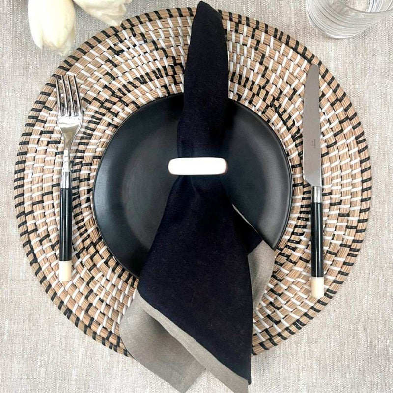 Terra woven placemat in seagrass styled with black napkin and white napkin ring.