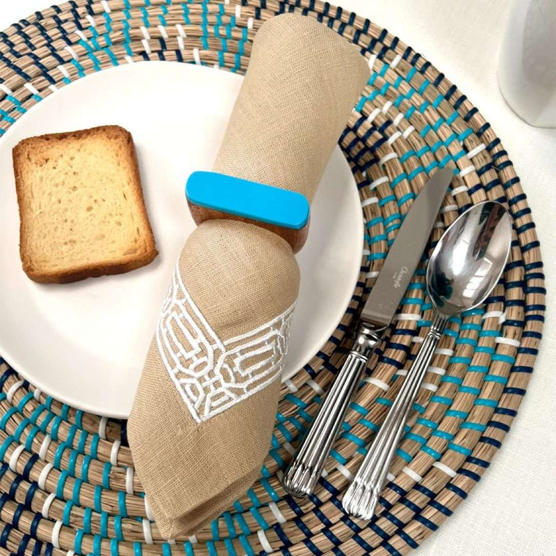 Gaia woven seagrass placemats in black and blue by Von Gern Home with blue napkin ring.