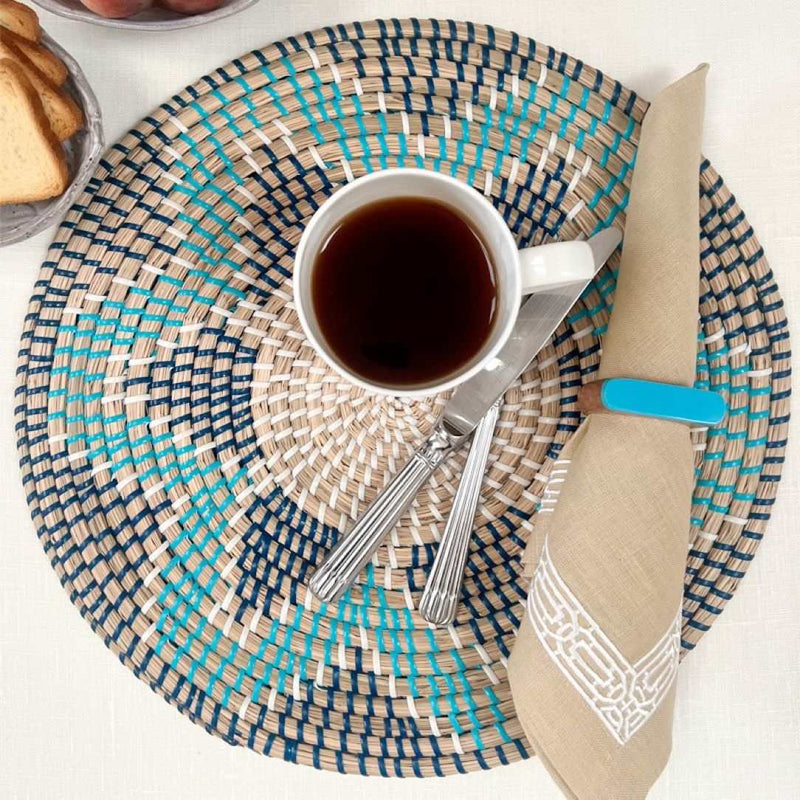 Gaia woven seagrass placemats in black and blue on luxury breakfast table setting.