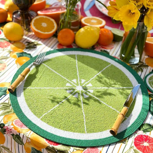 Lime green hand-beaded placemat, citrus-inspired by Kim Seybert side view.