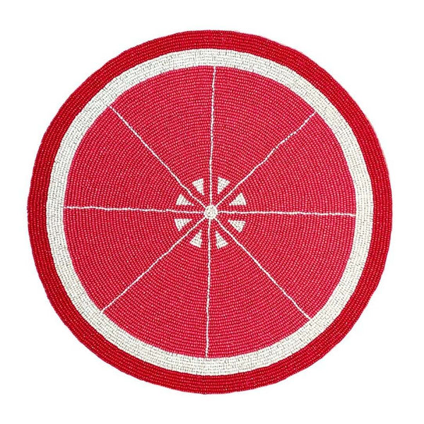 Grapefruit hand-beaded placemat in reddish-pink by Von Gern Home.