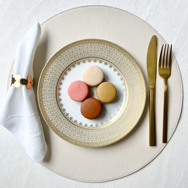 Reversible placemat in blush pink and cream faux leather showing cream side.