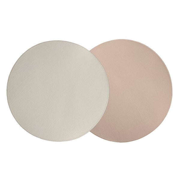 Reversible placemat in blush pink and cream faux leather by Von Gern Home.