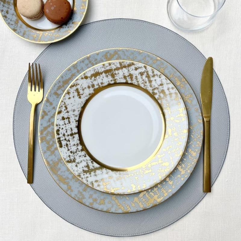 Reversible placemat in steel blue and light blue faux leather styled light blue side.