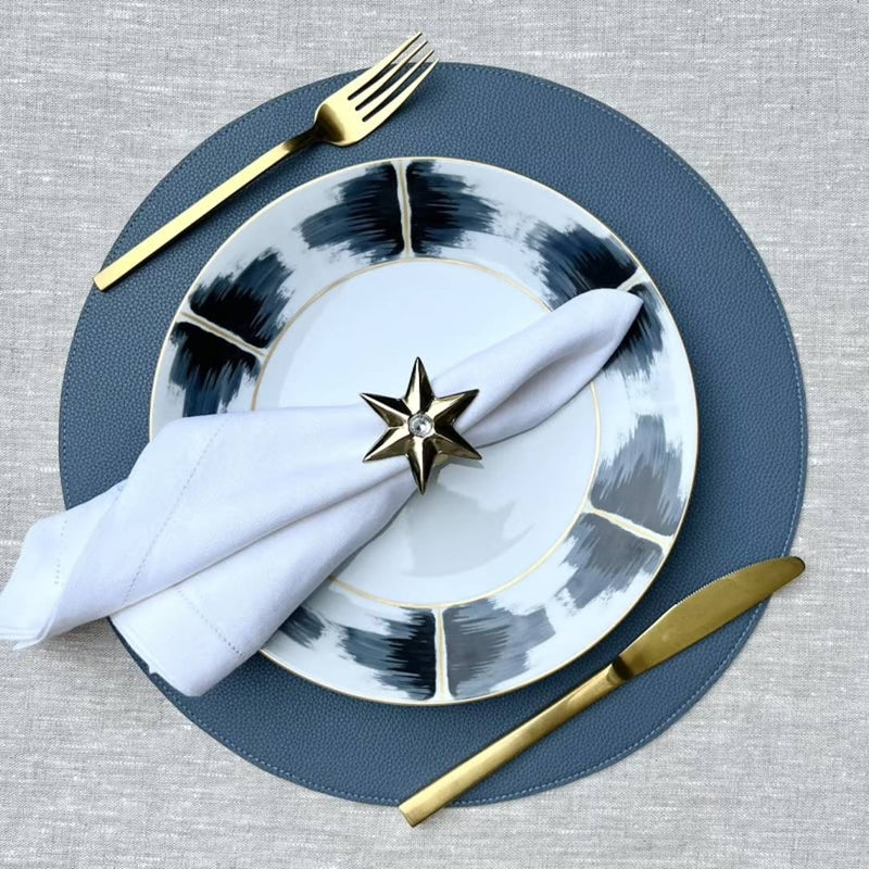 Reversible placemat in steel blue and light blue faux leather styled steel blue side.