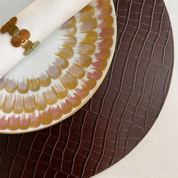 Reversible croco faux leather placemat in light brown and chocolate on dark brown side.