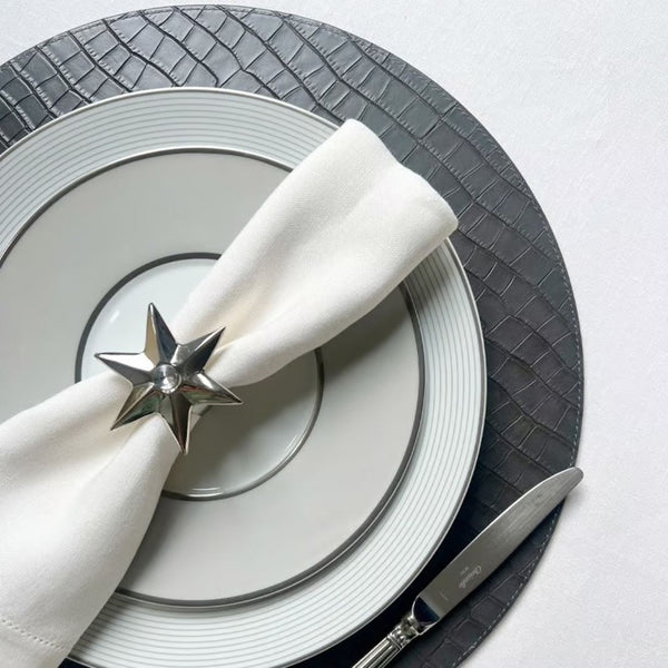 Reversible croco placemat in mustard yellow and charcoal black styled on silver grey tablescape.