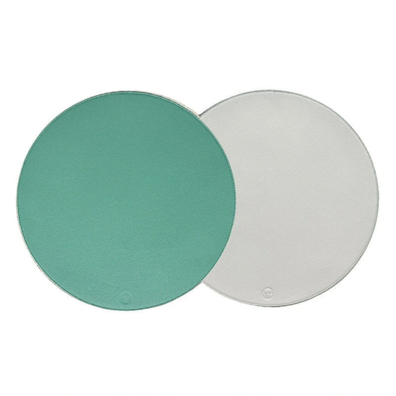 Reversible placemat in turquoise and white faux leather by Von Gern Home.