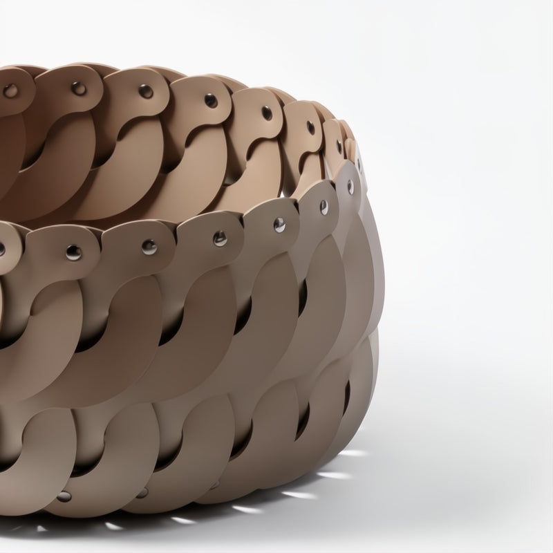 Close-up of the Alicante small round storage basket in taupe regenerated leather with interlocking S-shaped design by Pinetti