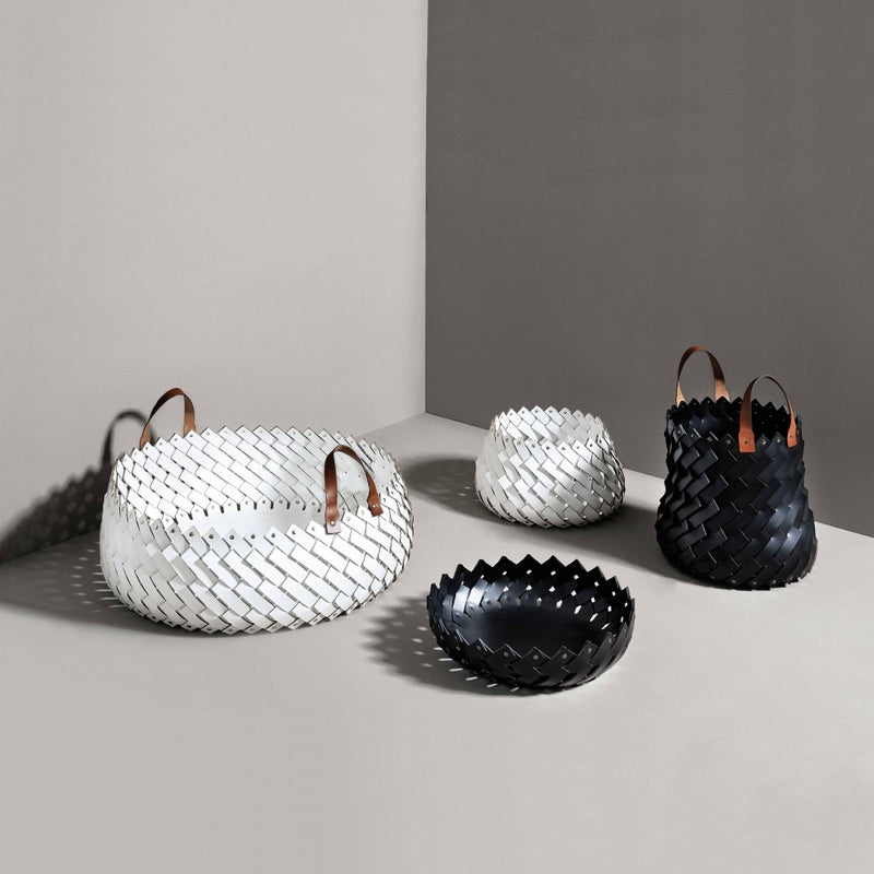 Set of woven baskets in white, black, and gray on a neutral background