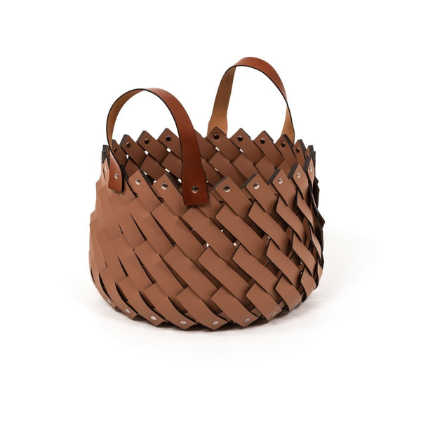 Brown woven basket with leather handles on a white background